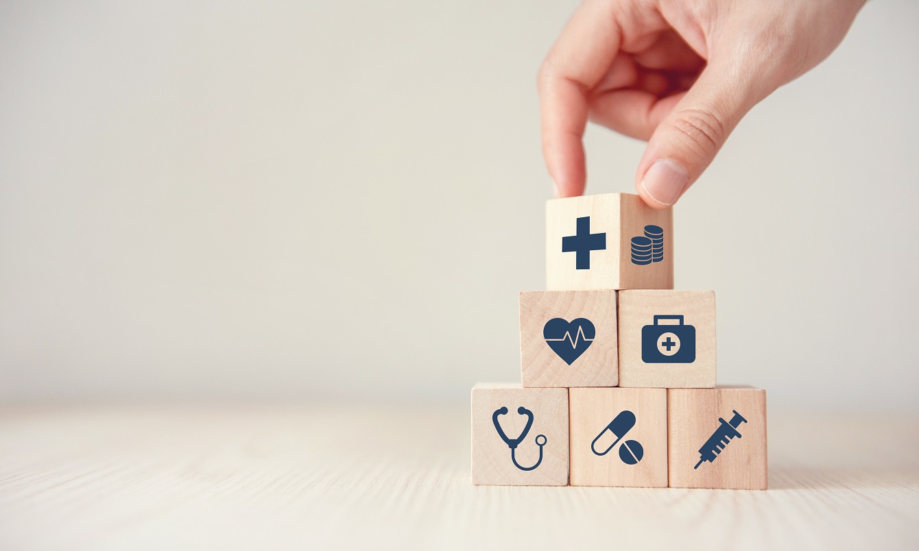 Health insurance concept reduce medical expenses hand flip wood cube with icon healthcare medical coin wood background copy space u